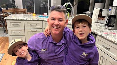 Kyle Denmark with his sons in Denmark Lawn purple